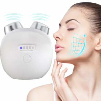 Woman using a facial massager device on her cheek.