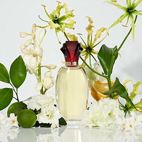 Perfume bottle surrounded by flowers and citrus fruits.